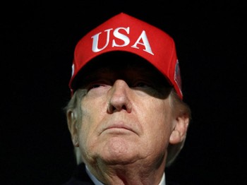 U.S. President Donald Trump looks on after disembarking Air Force One as he arrives at Joint Base Andrews in Maryland, U.S., April 12, 2026.  REUTERS/Kevin Lamarque