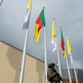 A soldier stands guard next to fluttering Cameroonian and Vatican flags at Yaounde Nsimalen International Airport, ahead of Pope Leo XIV's departure for Bamenda, where he will attend a meeting for peace and hold a holy Mass, in Yaounde, Cameroon, Apr