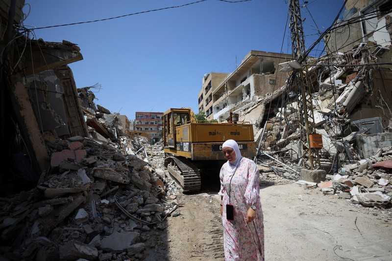 People gather at the site of an Israeli strike carried out before a 10-day ceasefire between Lebanon and Israel went into effect, in Tyre, Lebanon, April 17, 2026. REUTERS/Louisa Gouliamaki