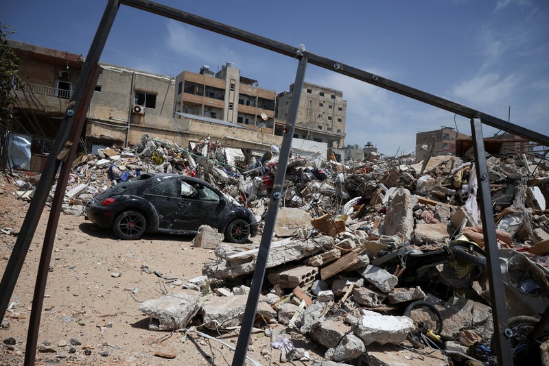 People gather at the site of an Israeli strike carried out before a 10-day ceasefire between Lebanon and Israel went into effect, in Tyre, Lebanon, April 17, 2026. REUTERS/Louisa Gouliamaki