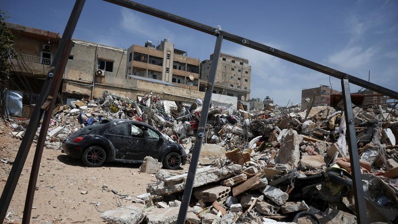 People gather at the site of an Israeli strike carried out before a 10-day ceasefire between Lebanon and Israel went into effect, in Tyre, Lebanon, April 17, 2026. REUTERS/Louisa Gouliamaki