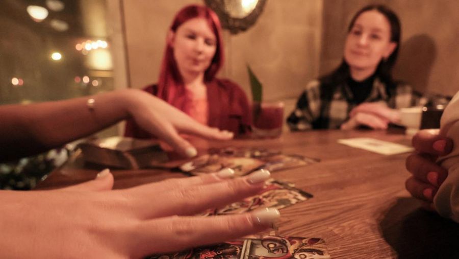 Fortune teller Arina Frants lays out Tarot cards on a table in the voodoo-themed bar Marie Laveau in Moscow, Russia February 17, 2026. REUTERS/Shamil Zhumatov