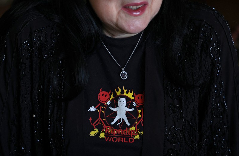 Fortune teller Arina Frants lays out Tarot cards on a table in the voodoo-themed bar Marie Laveau in Moscow, Russia February 17, 2026. REUTERS/Shamil Zhumatov