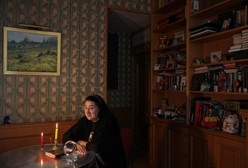 Fortune teller Arina Frants lays out Tarot cards on a table in the voodoo-themed bar Marie Laveau in Moscow, Russia February 17, 2026. REUTERS/Shamil Zhumatov