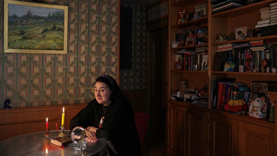 Fortune teller Arina Frants lays out Tarot cards on a table in the voodoo-themed bar Marie Laveau in Moscow, Russia February 17, 2026. REUTERS/Shamil Zhumatov