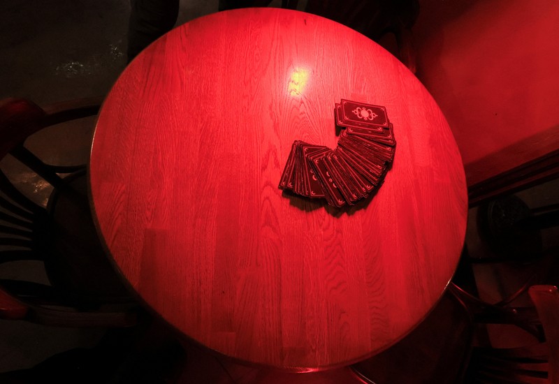 Fortune teller Arina Frants lays out Tarot cards on a table in the voodoo-themed bar Marie Laveau in Moscow, Russia February 17, 2026. REUTERS/Shamil Zhumatov