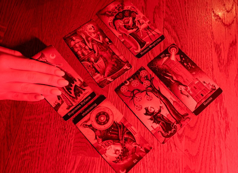 Fortune teller Arina Frants lays out Tarot cards on a table in the voodoo-themed bar Marie Laveau in Moscow, Russia February 17, 2026. REUTERS/Shamil Zhumatov