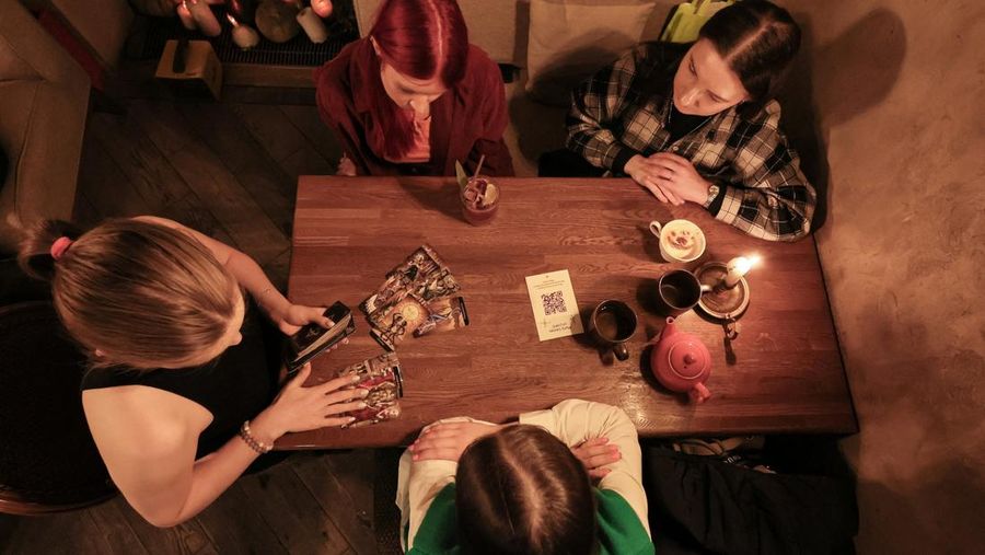 Fortune teller Arina Frants lays out Tarot cards on a table in the voodoo-themed bar Marie Laveau in Moscow, Russia February 17, 2026. REUTERS/Shamil Zhumatov