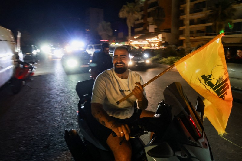 Para pengungsi bereaksi saat mereka kembali ke rumah mereka dengan kendaraan yang membawa barang-barang di atapnya setelah gencatan senjata 10 hari antara Lebanon dan Israel mulai berlaku, di Sidon, Lebanon, 17 April 2026. (REUTERS/Aziz Taher)