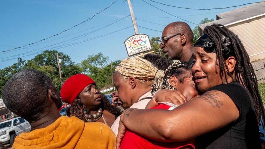 SHREVEPORT, LOUISIANA - APRIL 19: Syrnerica Pugh (R), is comforted while grieving the death of her nieces and nephews on April 19, 2026 in Shreveport, Louisiana. Eight children were killed and two women were wounded during a domestic violence incident in the early morning hours, according to local authorities.   Brandon Bell/Getty Images/AFP (Photo by Brandon Bell / GETTY IMAGES NORTH AMERICA / Getty Images via AFP)