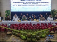 Petugas memasang garis polisi pada barang bukti saat konferensi pers Pengungkapan Kasus Penyalahgunaan BBM dan Elipiji Subsidi di Bareskrim Polri, Jakarta, Selasa (21/4/2026). (CNBC Indonesia/Faisal Rahman)