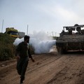 An Israeli soldier walks near a military vehicle, on the Israeli side of the Israel-Lebanon border, in northern Israel, April 26, 2026. REUTERS/Shir Torem