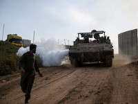 An Israeli soldier walks near a military vehicle, on the Israeli side of the Israel-Lebanon border, in northern Israel, April 26, 2026. REUTERS/Shir Torem