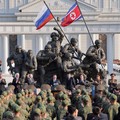 Russia's Defence Minister Andrey Belousov and Russia's State Duma Chairman Vyacheslav Volodin clap as North Korean leader Kim Jong Un speaks during the opening ceremony of the Memorial Museum of Combat Feats at the Overseas Military Operations honour