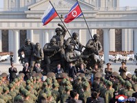 Russia's Defence Minister Andrey Belousov and Russia's State Duma Chairman Vyacheslav Volodin clap as North Korean leader Kim Jong Un speaks during the opening ceremony of the Memorial Museum of Combat Feats at the Overseas Military Operations honour