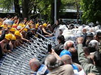 Polisi menghalangi para penambang Doruk Madencilik yang melakukan mogok makan untuk berbaris ke kementerian energi di Ankara, Turki, Senin (27/4/2026). (REUTERS/Efekan Akyuz)