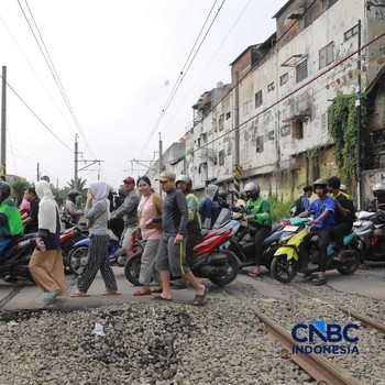 KA Jarak Jauh melintas di samping taksi Green SM yang tertabrak KRL di perlintasan kereta Jalan Ampera, Bekasi, Selasa (28/4/2026). Perlintasan ini berjarak 300 meter dari Stasiun Bekasi Timur. (CNBC Indonesia/Muhammad Sabki)