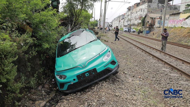 Kereta Krl melintas disamping taksi Green SM yang tertabrak KRL di perlintasan kereta Jalan Ampera, Bekasi, Selasa (28/4/2026). (CNBC Indonesia/Muhammad Sabki)