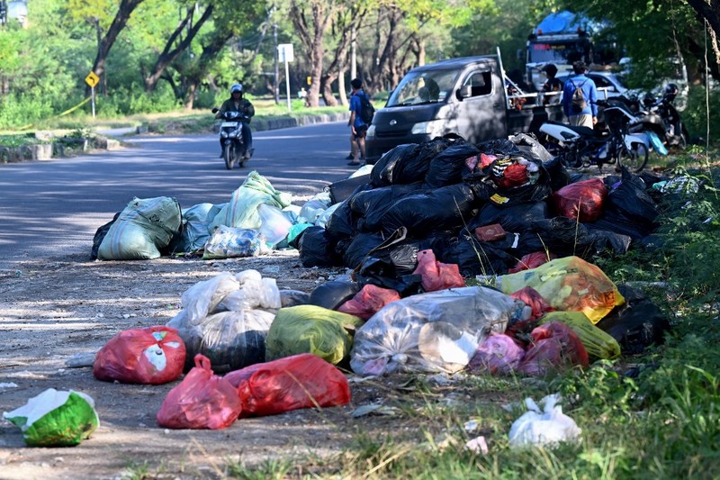 Sampah plastik terlihat berserakan di bawah pohon bakau di pusat konservasi bakau dekat Denpasar di pulau wisata Bali, pada 30 April 2026. (Photo by SONNY TUMBELAKA / AFP)