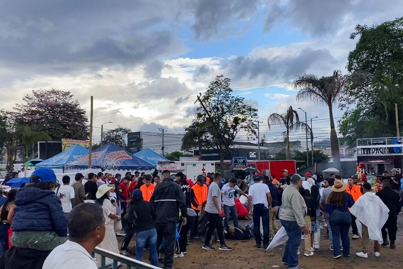 Orang-orang berdiri di dekat truk monster setelah pengemudinya kehilangan kendali atas kendaraan tersebut dan menabrak para penonton, menewaskan beberapa orang dan melukai yang lainnya, di Popayan, provinsi Cauca, Kolombia, 3 Mei 2026. (REUTERS/Henry Laserna)