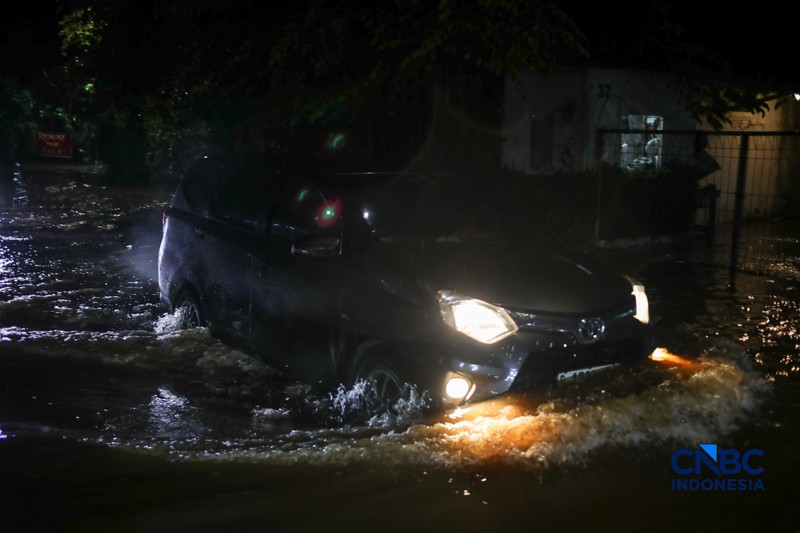 Warga menerobos banjir yang merendam ruas Jalan Benda Bawah, Cilandak Timur, Jakarta, Senin (4/5/2026). (CNBC Indonesia/Faisal Rahman)