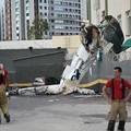 Firefighters work next to the remains of a plane after it crashed into a building in Belo Horizonte, Brazil, May 4, 2026. REUTERS/Washington Alves