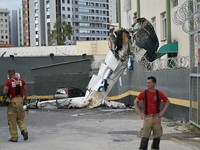Firefighters work next to the remains of a plane after it crashed into a building in Belo Horizonte, Brazil, May 4, 2026. REUTERS/Washington Alves