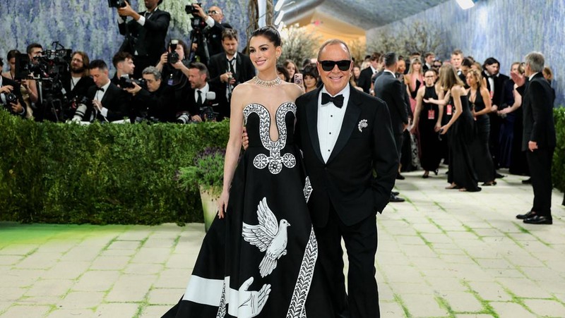 Anne Hathaway and Michael Kors pose during the Met Gala, an annual fundraising gala held for the benefit of the Metropolitan Museum of Art's Costume Institute with this year's theme 'Costume Art' in New York City, New York, U.S., May 4, 2026. REUTERS