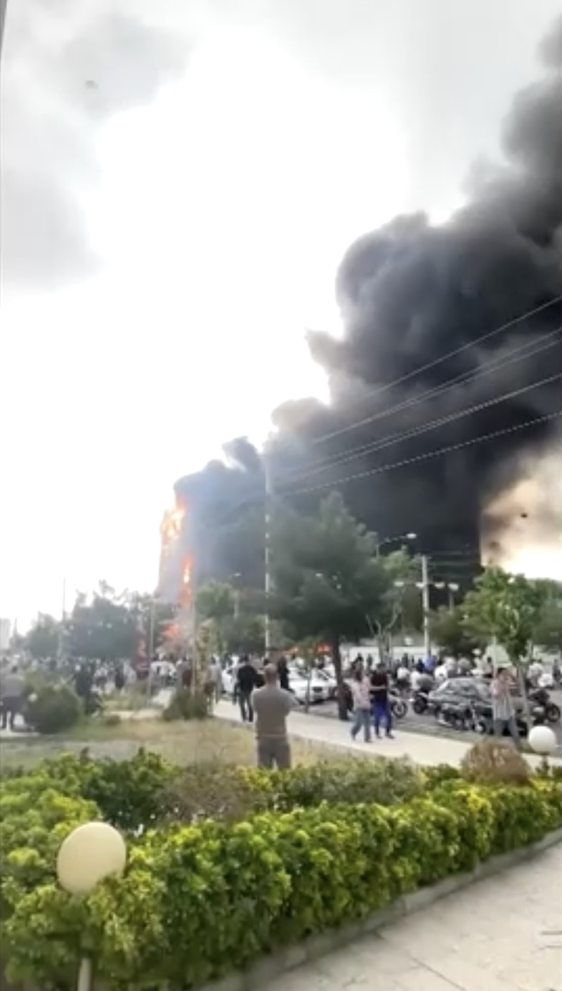 Flames and smoke rise after a fire broke out at a shopping center in Tehran, Iran, May 5, 2026, in this screen grab taken from social media video. SOCIAL MEDIA/via REUTERS  THIS IMAGE HAS BEEN SUPPLIED BY A THIRD PARTY. NO RESALES. NO ARCHIVES. NEWS USE ONLY.  Verification: - Buildings, utility poles, trees and road layout matched the archive and satellite imagery of the area - Coordinates:  35.70833490893601, 51.037304565984954 - Date verified from state news agency IRNA which reported the fire occurred on Tuesday - Several corroborating eyewitness videos uploaded on May 5 also showed fire at the same building