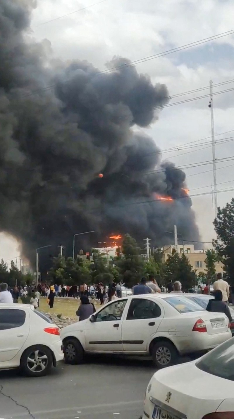 Flames and smoke rise after a fire broke out at a shopping center in Tehran, Iran, May 5, 2026, in this screen grab taken from social media video. SOCIAL MEDIA/via REUTERS  THIS IMAGE HAS BEEN SUPPLIED BY A THIRD PARTY. NO RESALES. NO ARCHIVES. NEWS USE ONLY.  Verification: - Buildings, utility poles, trees and road layout matched the archive and satellite imagery of the area - Coordinates:  35.70833490893601, 51.037304565984954 - Date verified from state news agency IRNA which reported the fire occurred on Tuesday - Several corroborating eyewitness videos uploaded on May 5 also showed fire at the same building
