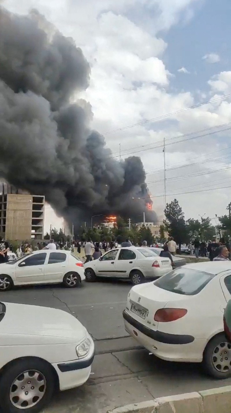 Flames and smoke rise after a fire broke out at a shopping center in Tehran, Iran, May 5, 2026, in this screen grab taken from social media video. SOCIAL MEDIA/via REUTERS  THIS IMAGE HAS BEEN SUPPLIED BY A THIRD PARTY. NO RESALES. NO ARCHIVES. NEWS USE ONLY.  Verification: - Buildings, utility poles, trees and road layout matched the archive and satellite imagery of the area - Coordinates:  35.70833490893601, 51.037304565984954 - Date verified from state news agency IRNA which reported the fire occurred on Tuesday - Several corroborating eyewitness videos uploaded on May 5 also showed fire at the same building