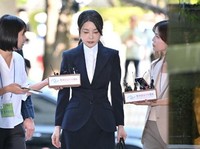 South Korea's former first lady Kim Keon Hee (C), wife of impeached former president Yoon Suk Yeol, arrives at a court to attend a hearing to review her arrest warrant requested by special prosecutors at the Seoul Central District Court in Seoul on A
