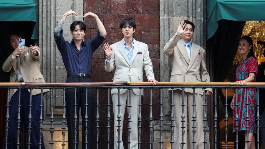Members of South Korean Kpop boy band BTS and Mexico's President Claudia Sheinbaum react as they stand on a balcony of the National Palace ahead of a series of concerts on the BTS World Tour "Arirang" in Mexico City, Mexico, May 6, 2026. REUTERS/Luis