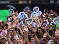 Fans of South Korean Kpop boy band BTS, known as ARMY, react on the day members of the band meet with Mexico's President Claudia Sheinbaum at the National Palace ahead of a series of concerts on the BTS World Tour "Arirang" in Mexico City, Mexico, Ma