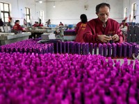 Employees work to assemble firework products at Chili Fireworks in Liling, Hunan province, China, April 10, 2026.  REUTERS/Go Nakamura