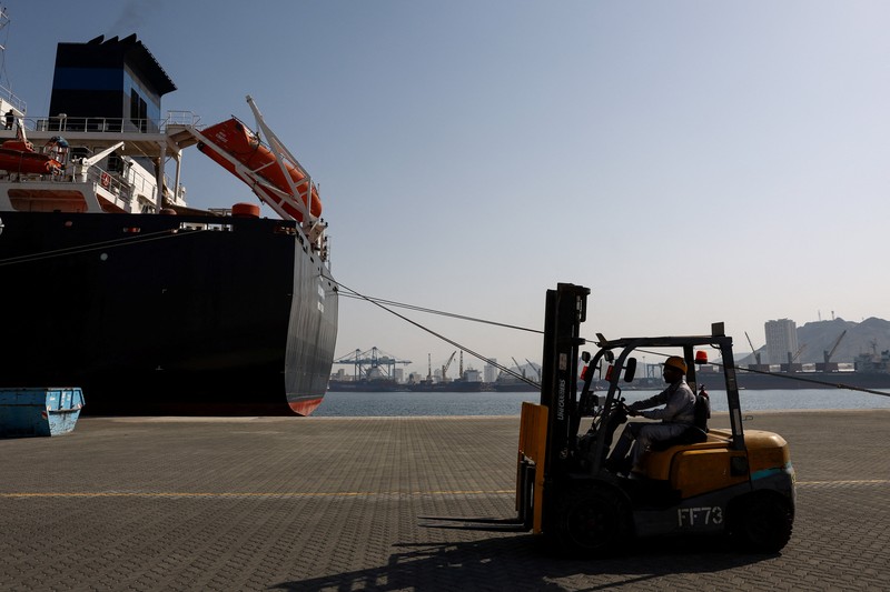 A man walks at the Port of Fujairah, as the U.S.-Israel conflict with Iran limits marine traffic in the Strait of Hormuz, in Fujairah, United Arab Emirates, May 6, 2026. REUTERS/Amr Alfiky