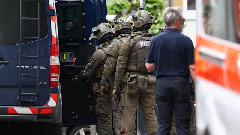 Para anggota pasukan polisi khusus Jerman memasuki sebuah van selama operasi menanggapi situasi penyanderaan di sebuah cabang bank tabungan di kota Sinzig, dekat Bonn, di negara bagian Rhineland-Palatinate, Jerman, 8 Mei 2026.