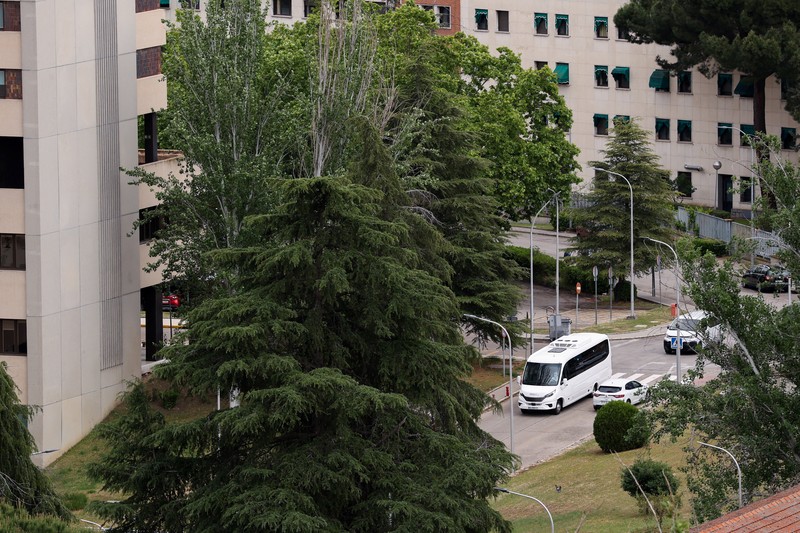 A bus carrying passengers of the cruise ship MV Hondius, which was affected by a hantavirus outbreak, at the Gomez Ulla Military Hospital, in Madrid, Spain, May 10, 2026. REUTERS/Alejandro Martinez Velez