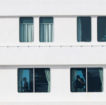 People aboard the cruise ship MV Hondius, which is affected by a hantavirus outbreak, at the port of Granadilla de Abona in Tenerife, Spain, May 10, 2026. REUTERS/Hannah McKay