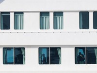 People aboard the cruise ship MV Hondius, which is affected by a hantavirus outbreak, at the port of Granadilla de Abona in Tenerife, Spain, May 10, 2026. REUTERS/Hannah McKay