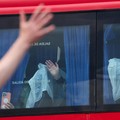 Passengers from the cruise ship MV Hondius affected by a hantavirus outbreak, gesture as they sit aboard a bus at the port of Granadilla de Abona, in Tenerife, Spain, May 10, 2026. REUTERS/Hannah McKay