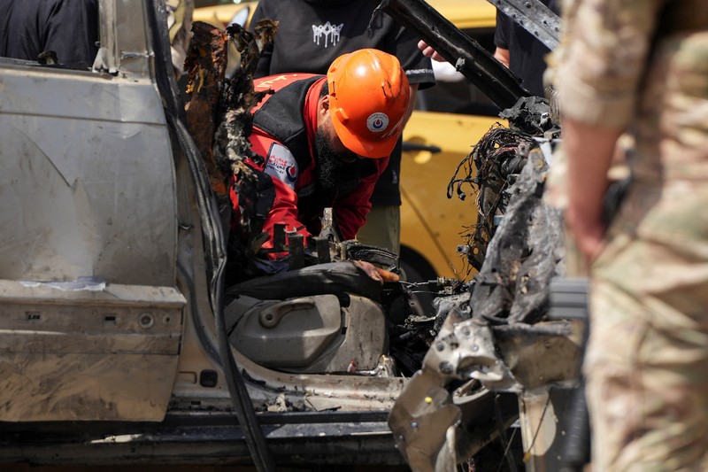 Tim penyelamat bekerja di lokasi serangan Israel terhadap sebuah mobil di daerah Jiyeh, selatan Beirut, Lebanon, Rabu (13/5/2026). (AFP/FADEL ITANI)