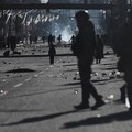 Seorang petugas polisi militer berjalan sementara seorang anak berdiri di antara bebatuan yang berserakan di jalan saat para pengunjuk rasa berdemonstrasi menentang pemerintahan Presiden Rodrigo Paz di tengah krisis ekonomi dan bahan bakar yang sedan