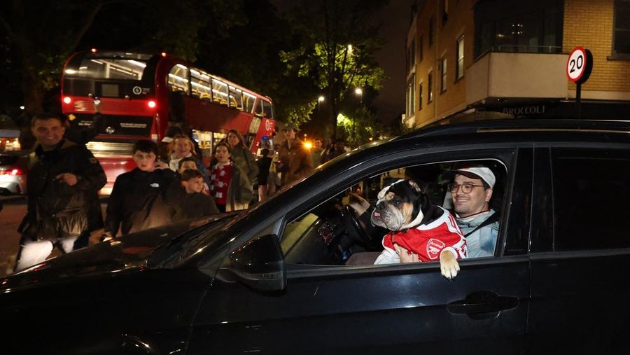 Para penggemar Arsenal merayakan kemenangan di luar stadion Emirates saat Arsenal memenangkan Liga Inggris di London, Inggris, Selasa (19/4/2026) malam waktu setempat. (Action Images via Reuters/Andrew Boyers)
