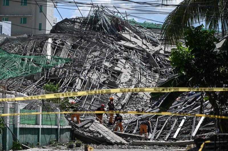 Petugas keselamatan tiba dilokasi bangunan yang sedang dalam proses pembangunan di Filipina roboh pada Minggu (24/5/2026) pagi. (REUTERS/Noel Celis)
