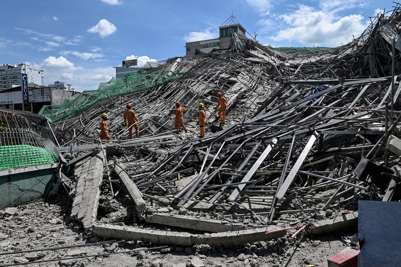 Petugas keselamatan tiba dilokasi bangunan yang sedang dalam proses pembangunan di Filipina roboh pada Minggu (24/5/2026) pagi. (REUTERS/Noel Celis)