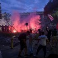 A group of demonstrators clash with riot police outside Serbia's parliament building during clashes that erupt at the end of an anti-government protest decrying corruption and calling for early elections following the collapse of a railway station ca