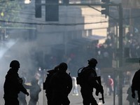 Police stand guard as they clash with demonstrators on the day of a march calling for the resignation of Bolivian President Rodrigo Paz, while the country’s economic and fuel crisis worsens due to a shortage of U.S. dollars and declining domestic e