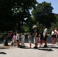 People queue to use a water fountain in Buttes Chaumont park, as temperatures reached up to 35 degrees Celsius, during a period of hot weather in Paris, France, May 25, 2026. REUTERS/Tom Nicholson