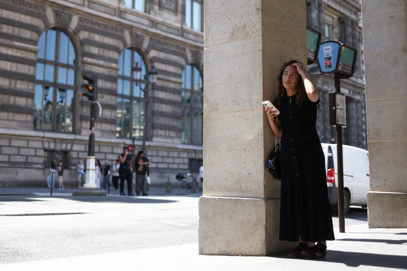 A woman with an umbrella walks at Plaza Puerta del Sol during a spring heatwave in Madrid, Spain, May 27, 2026. REUTERS/Kacper Pempel